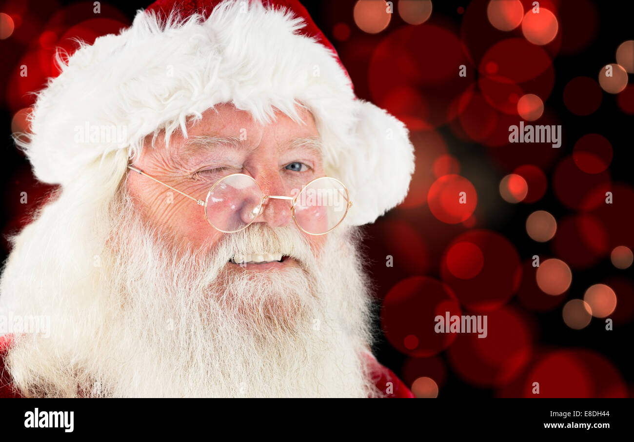 Composite image of santa claus winking Stock Photo - Alamy