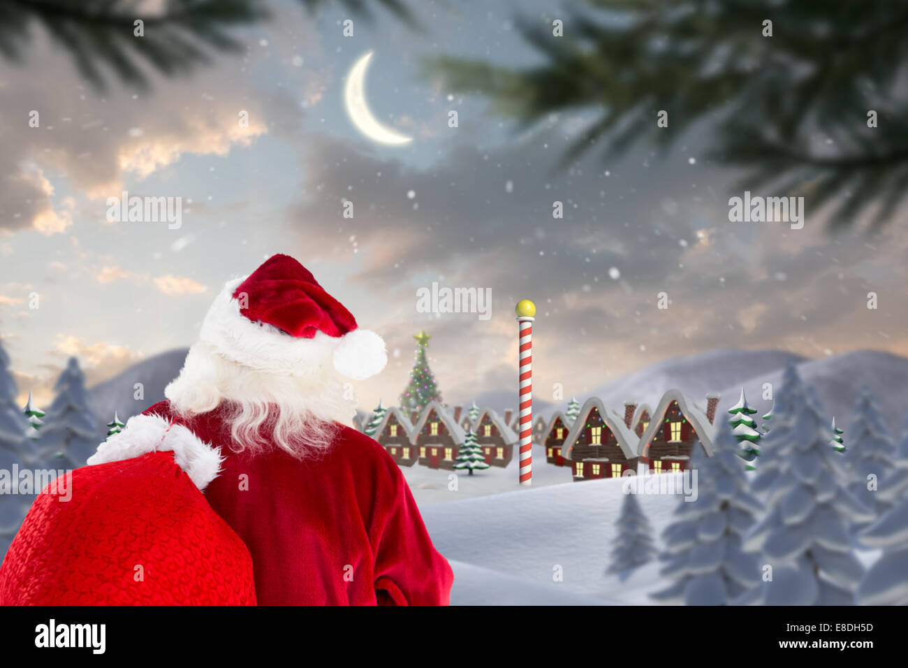 Composite image of santa claus carrying sack Stock Photo - Alamy