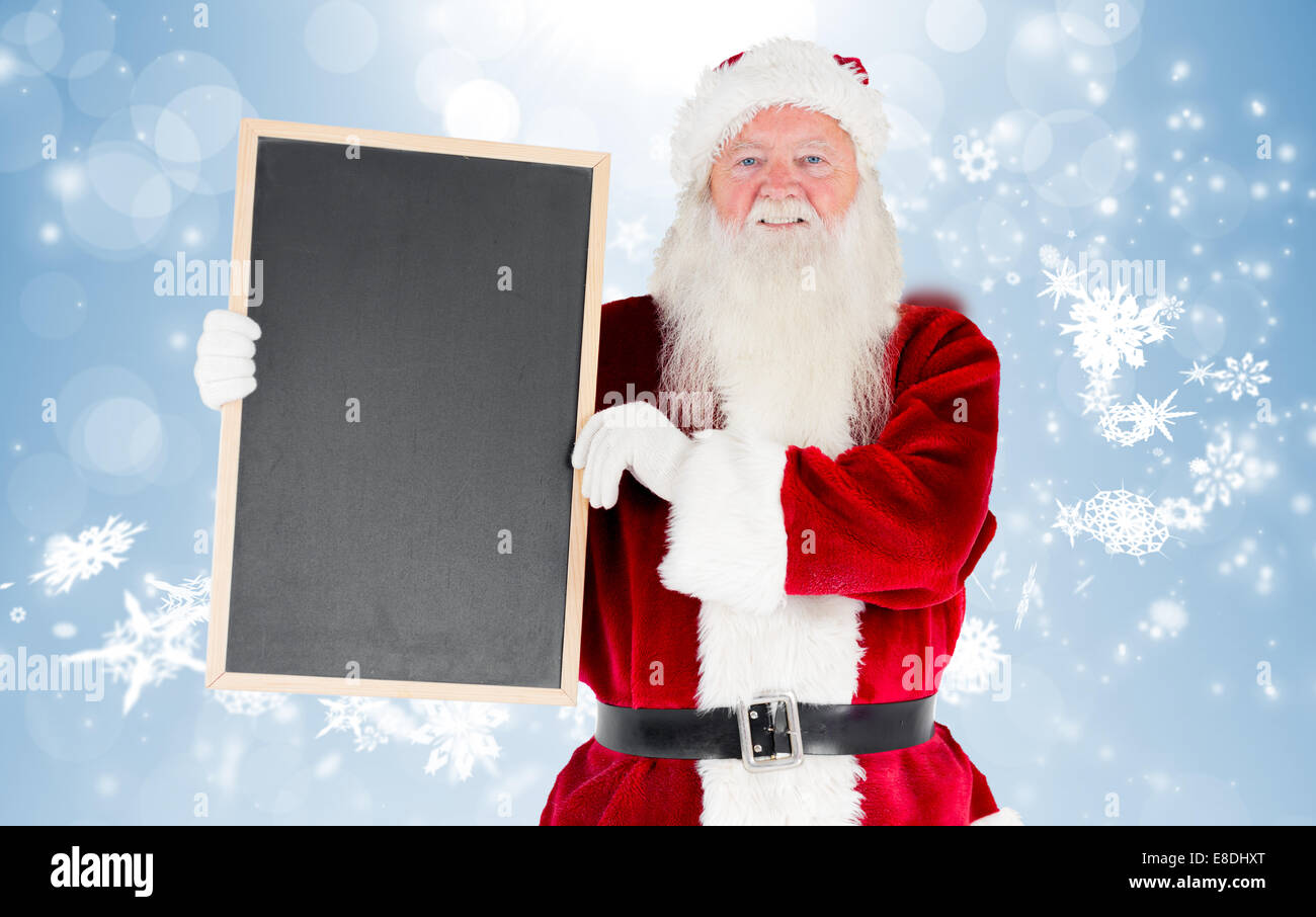 Composite image of santa claus showing blackboard Stock Photo - Alamy