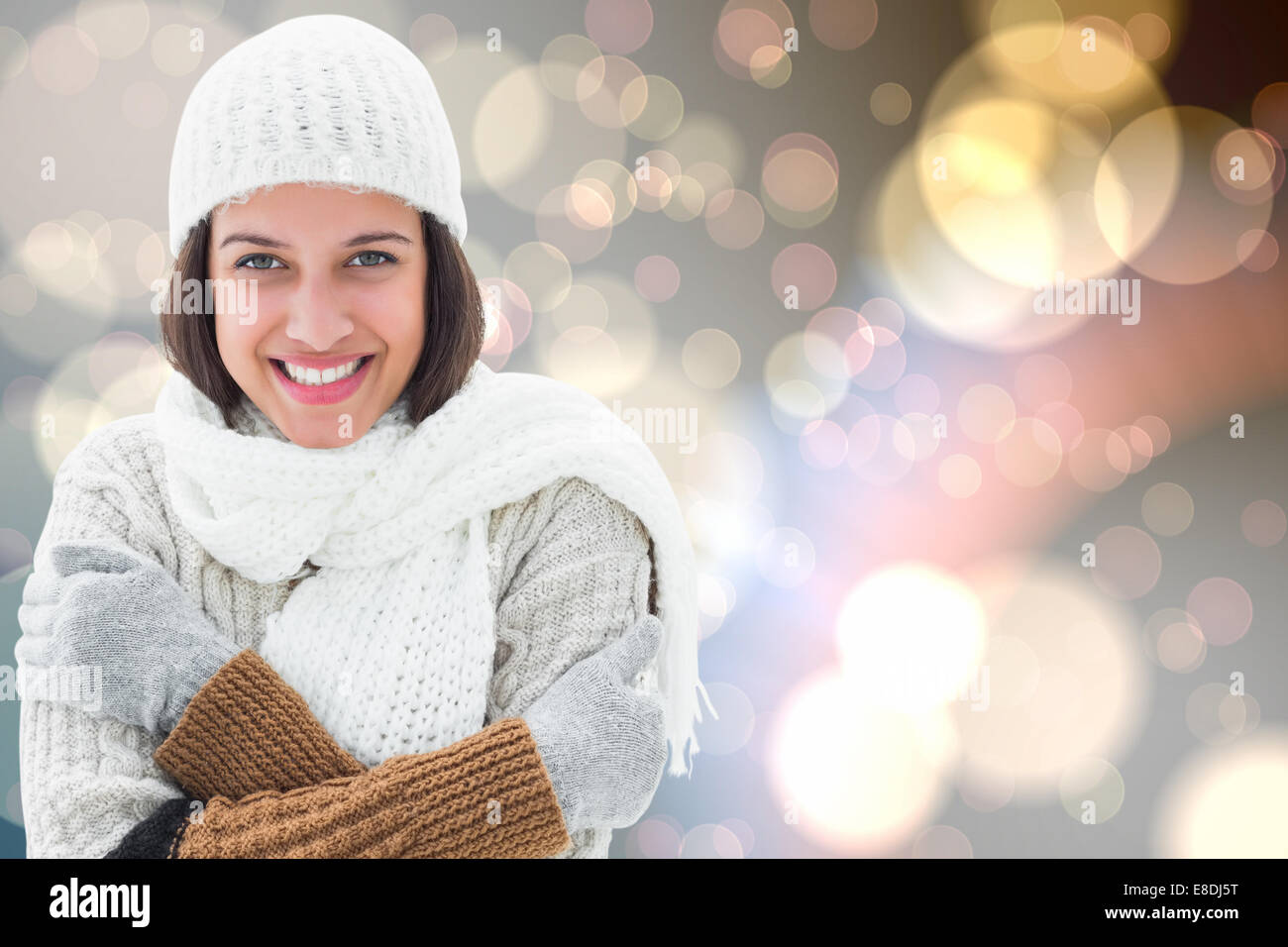 Composite image of brunette in warm clothing Stock Photo