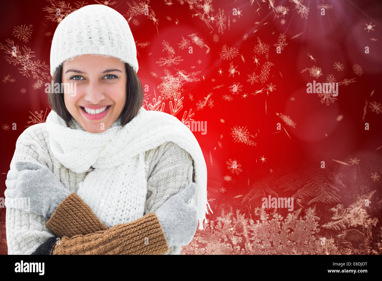 Composite image of brunette in warm clothing Stock Photo