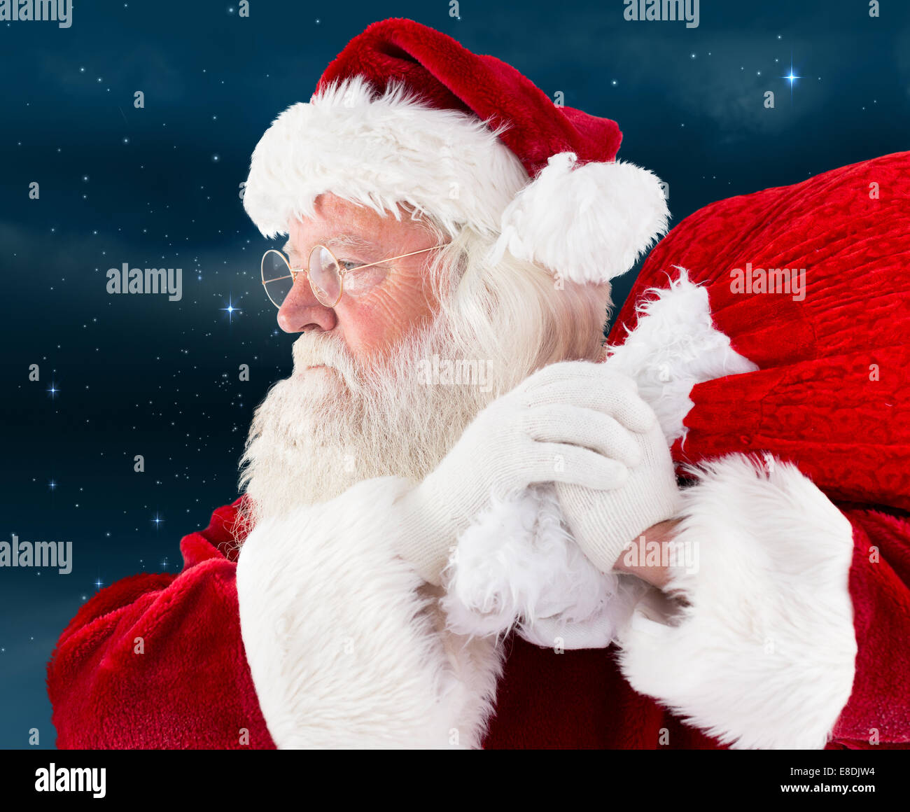 Composite image of santa claus carrying sack Stock Photo - Alamy