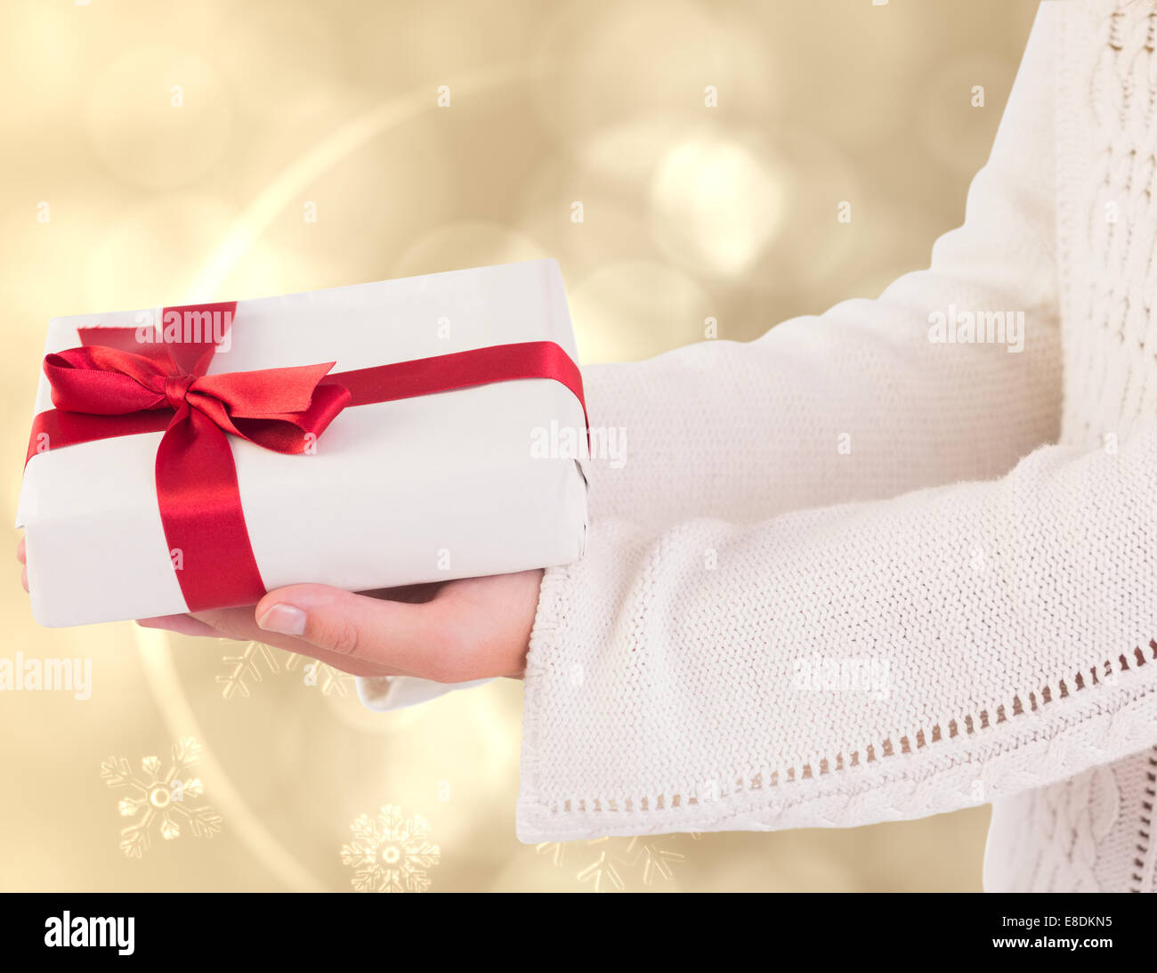 Composite image of woman offering a gift box Stock Photo