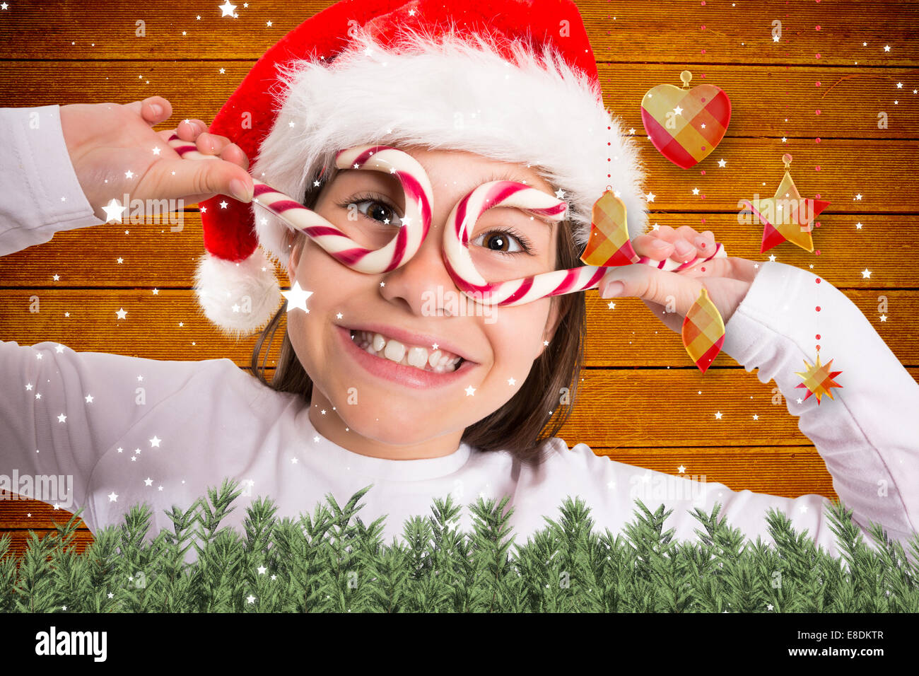 Composite image of festive little girl smiling at camera Stock Photo ...