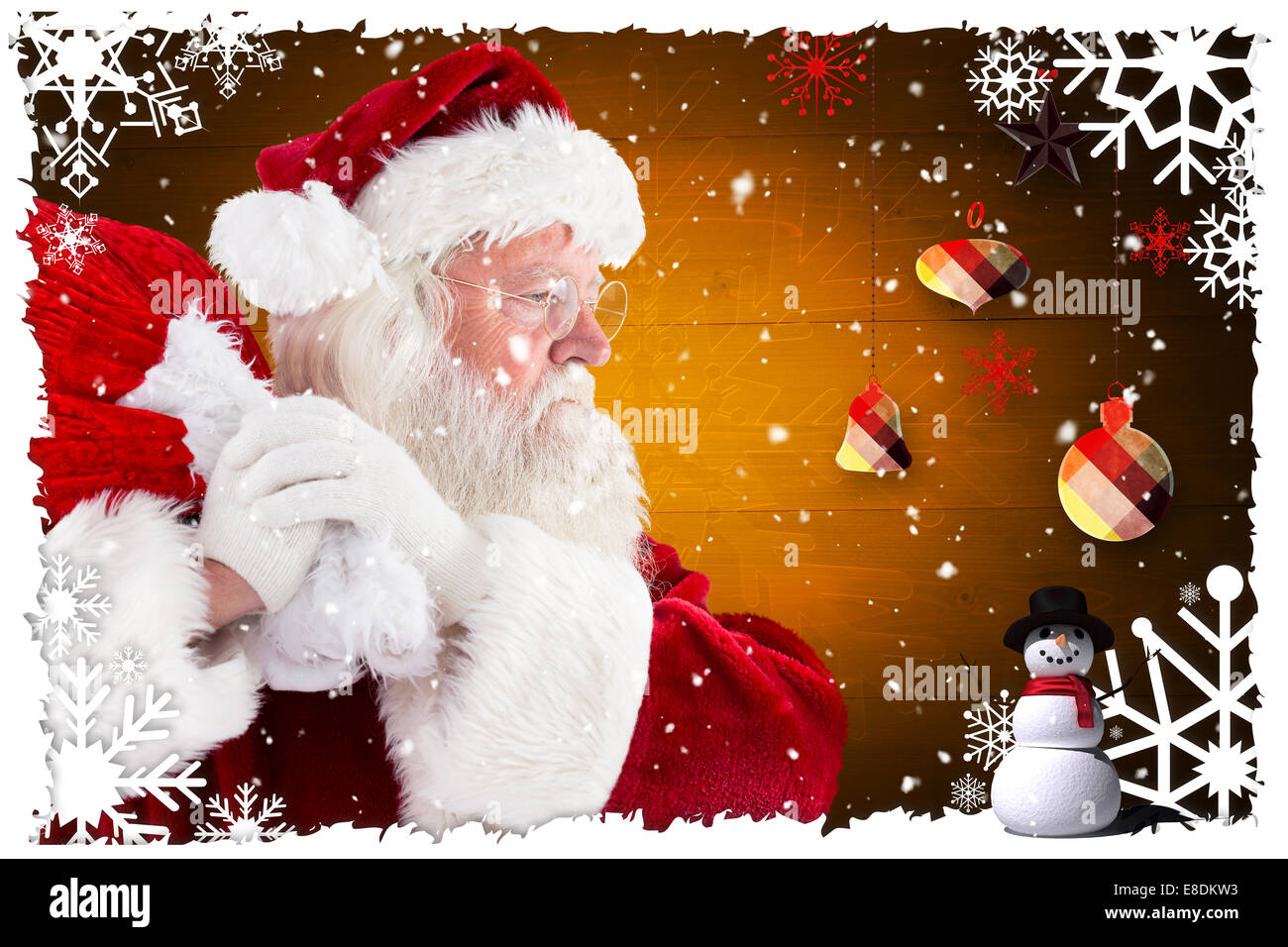 Composite image of santa claus carrying sack Stock Photo - Alamy