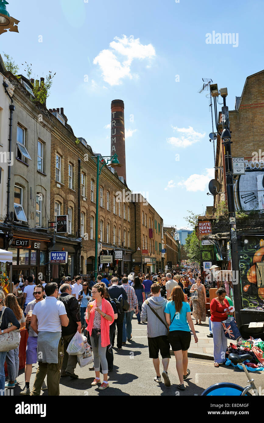 LONDON - JUNE 08, 2014: Tourists in Brick Lane on a busy sunny Sunday on June 08, 2014 in London. Stock Photo