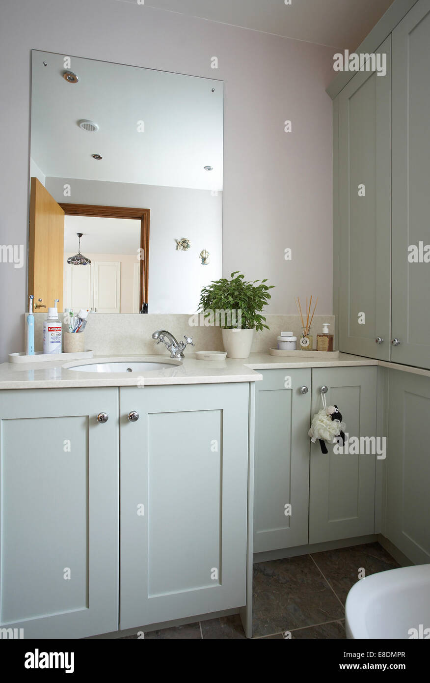 Bathroom interior in a home in the UK in a pastel blue - green color. Stock Photo