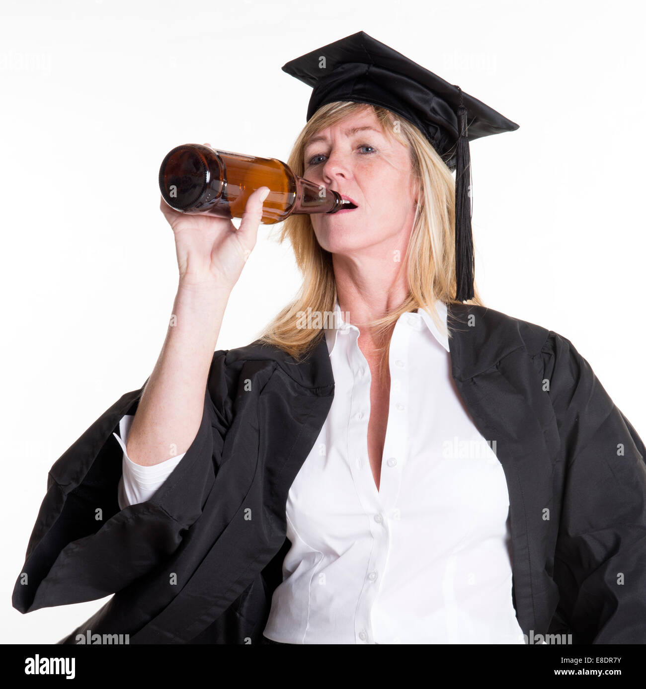 Beer drinking University student wearing cap and gown drinking beer