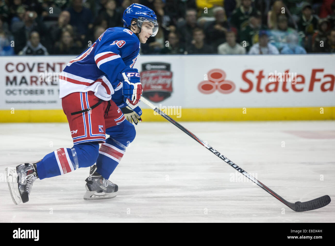October 3, 2014.  Doug Blaisdell (18) of the Kitchener Rangers carries the puck during a game between the London Knights and the Stock Photo