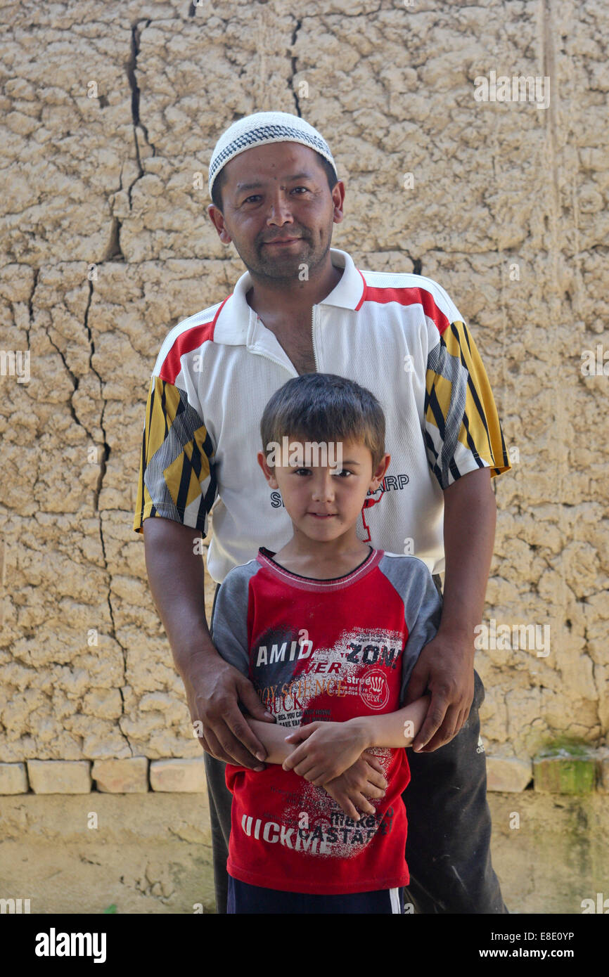 Uzbek father and son in a Kirgiz village near Osh, Kyrgyzstan Stock ...