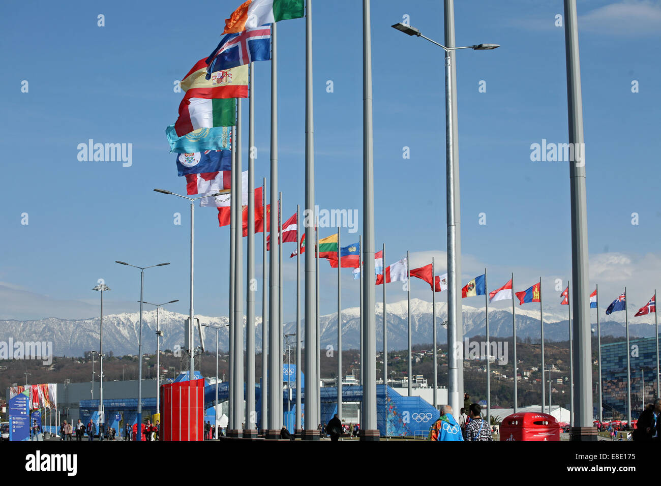 Curve of international flags mountains in the background Sochi Stock Photo