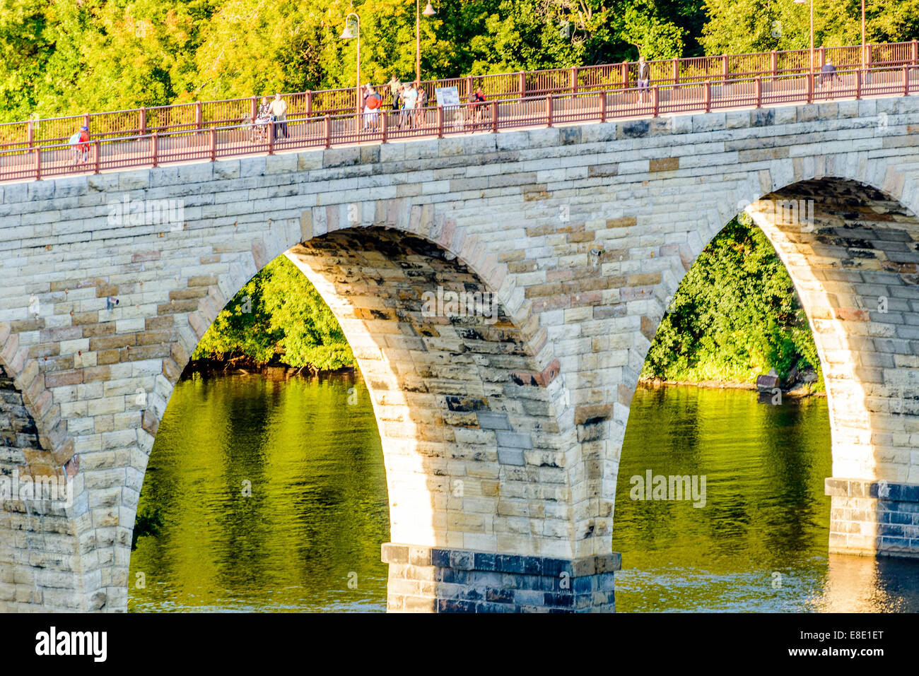 Minneapolis, MN, river and bridge with runners near downtown Stock Photo
