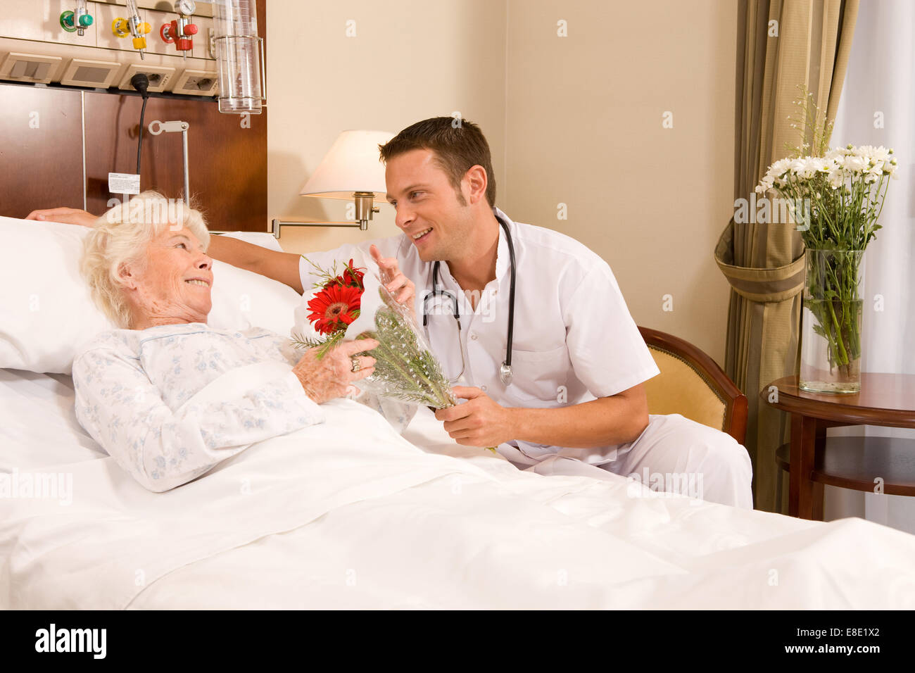 Doctors offering flowers Stock Photo Alamy