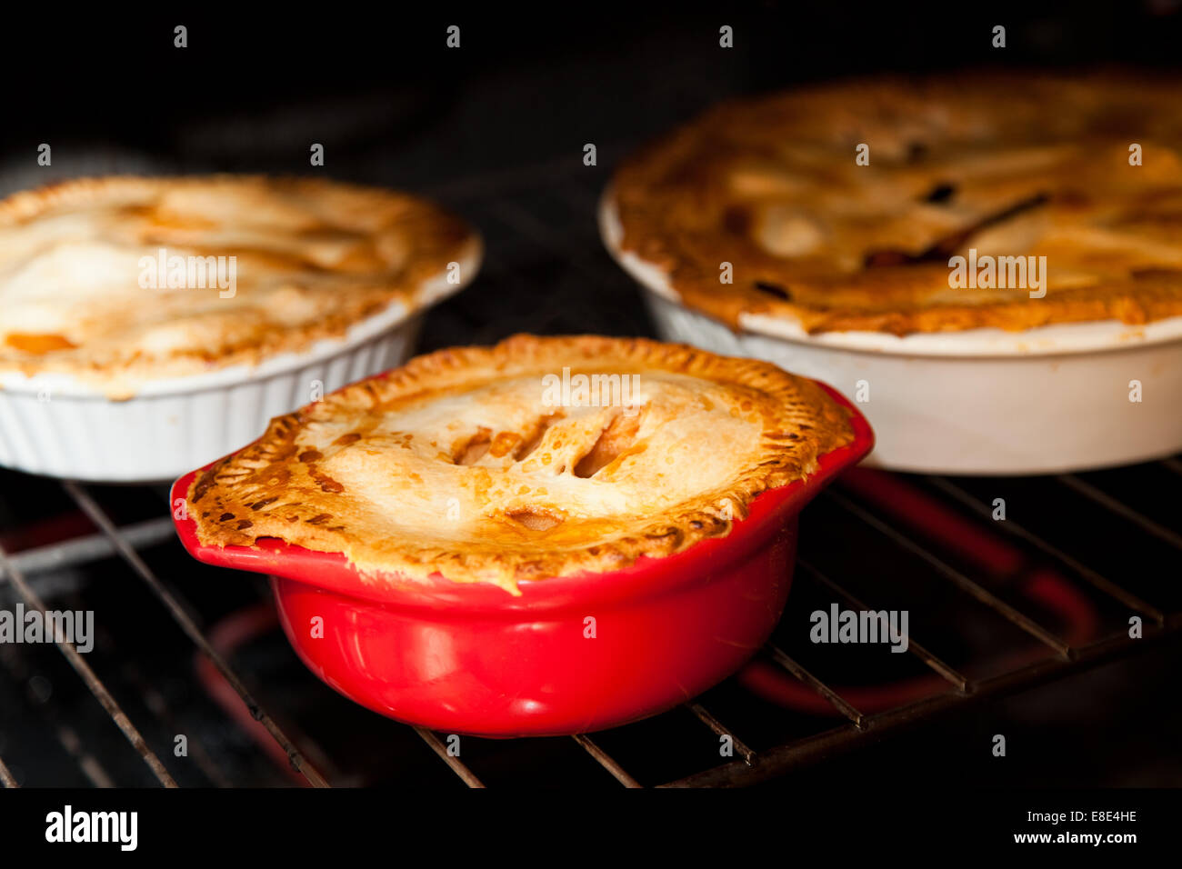 three apple pies cooking in the oven Stock Photo Alamy
