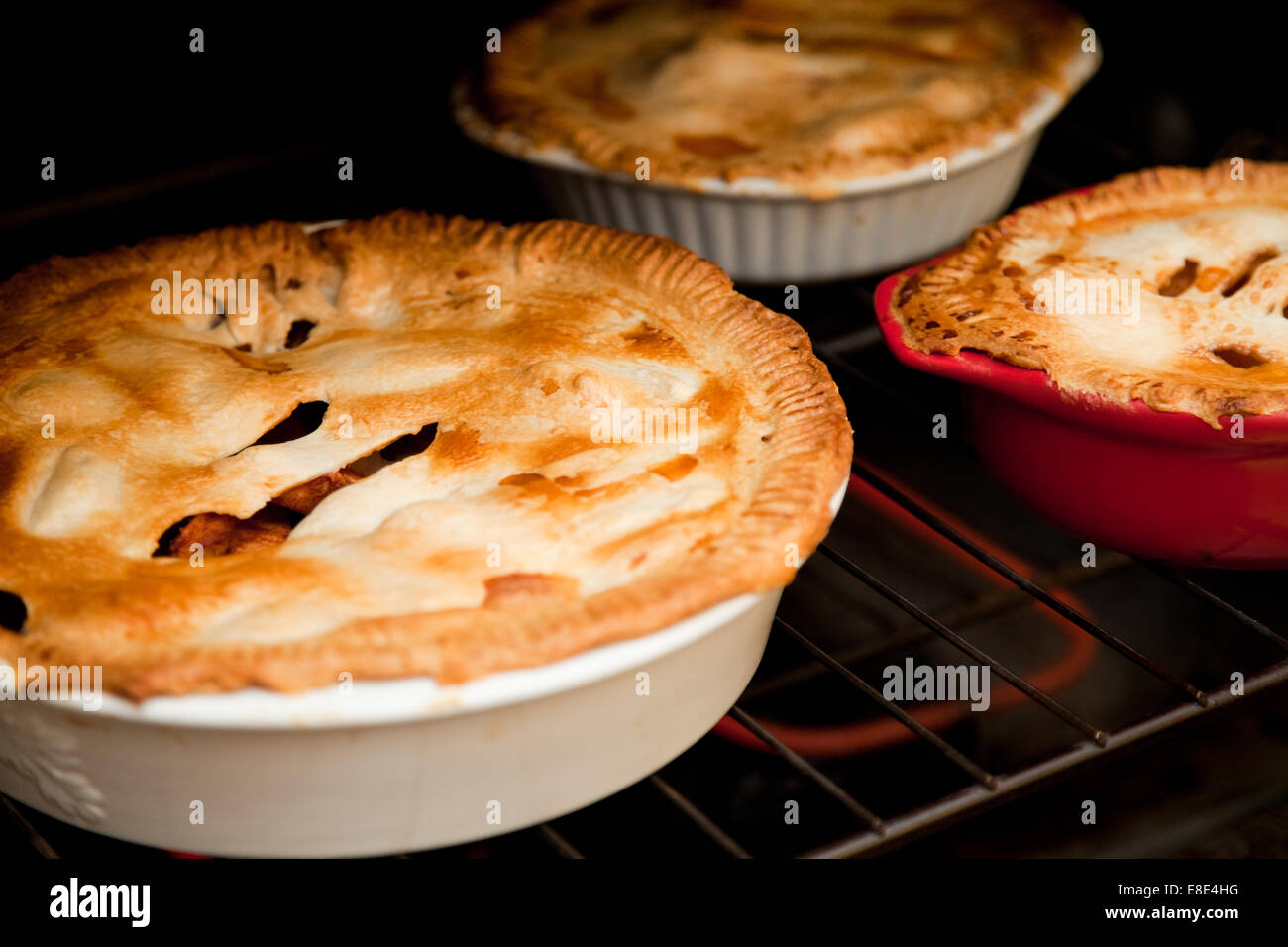 three apple pies cooking in the oven Stock Photo Alamy