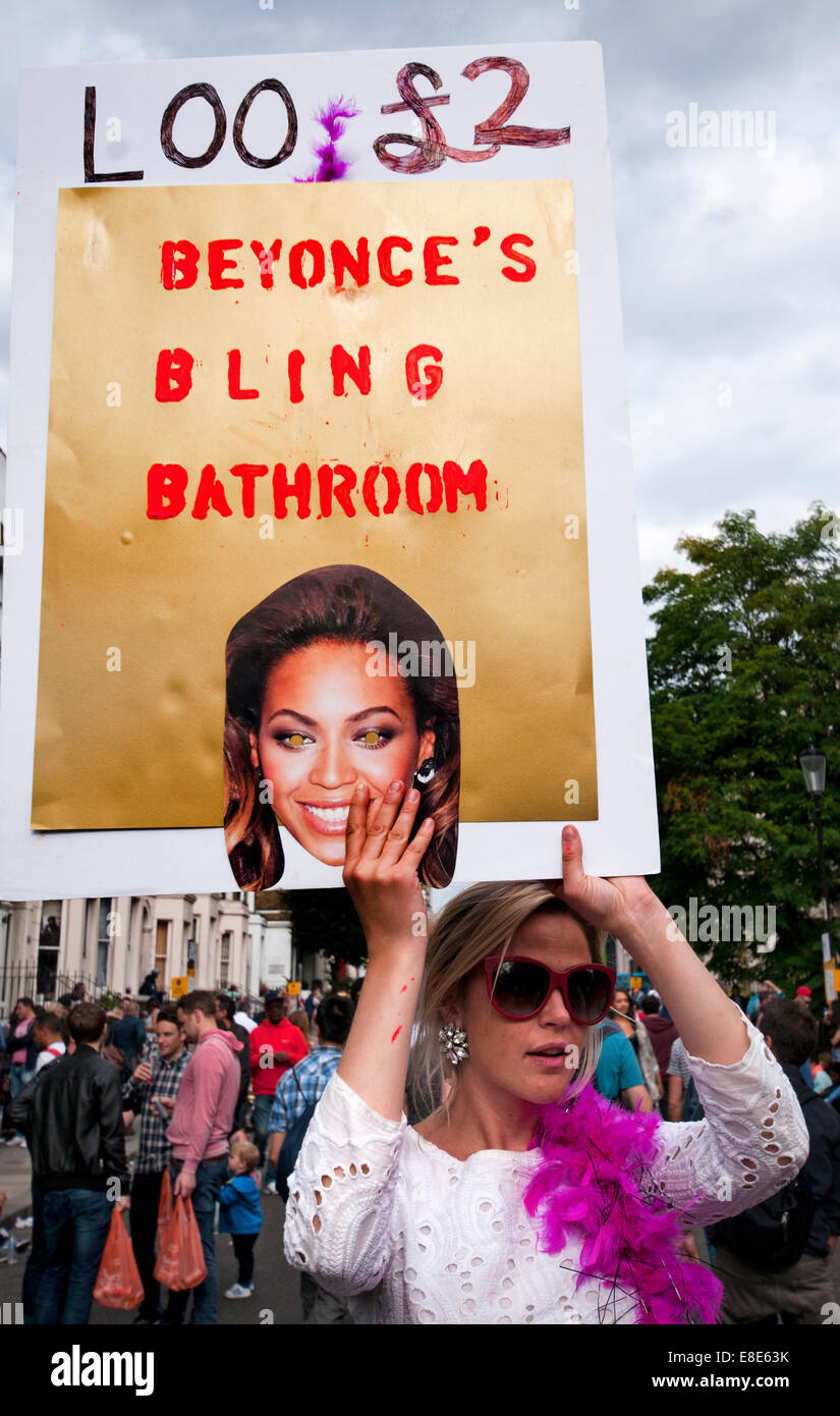 Woman announcing that her home loo is available to the public at Annual Notting Hill Carnival in London 2014 Stock Photo