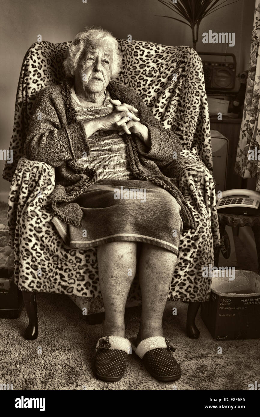 An elderly lady sitting in her chair reminiscing Stock Photo Alamy