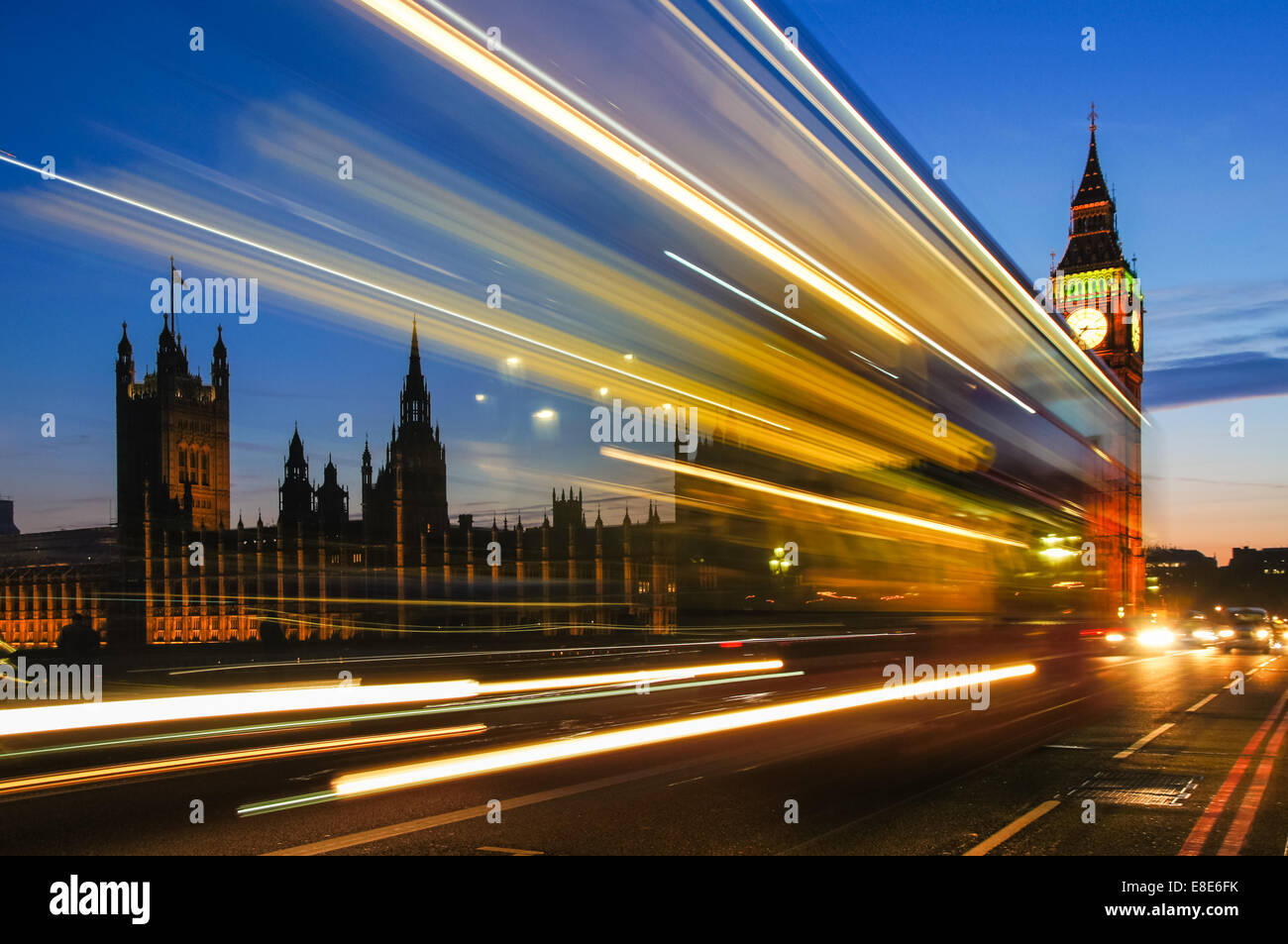 Light trails left by double decker bus passing by Big Ben on Westminster bridge, London England United Kingdom UK Stock Photo