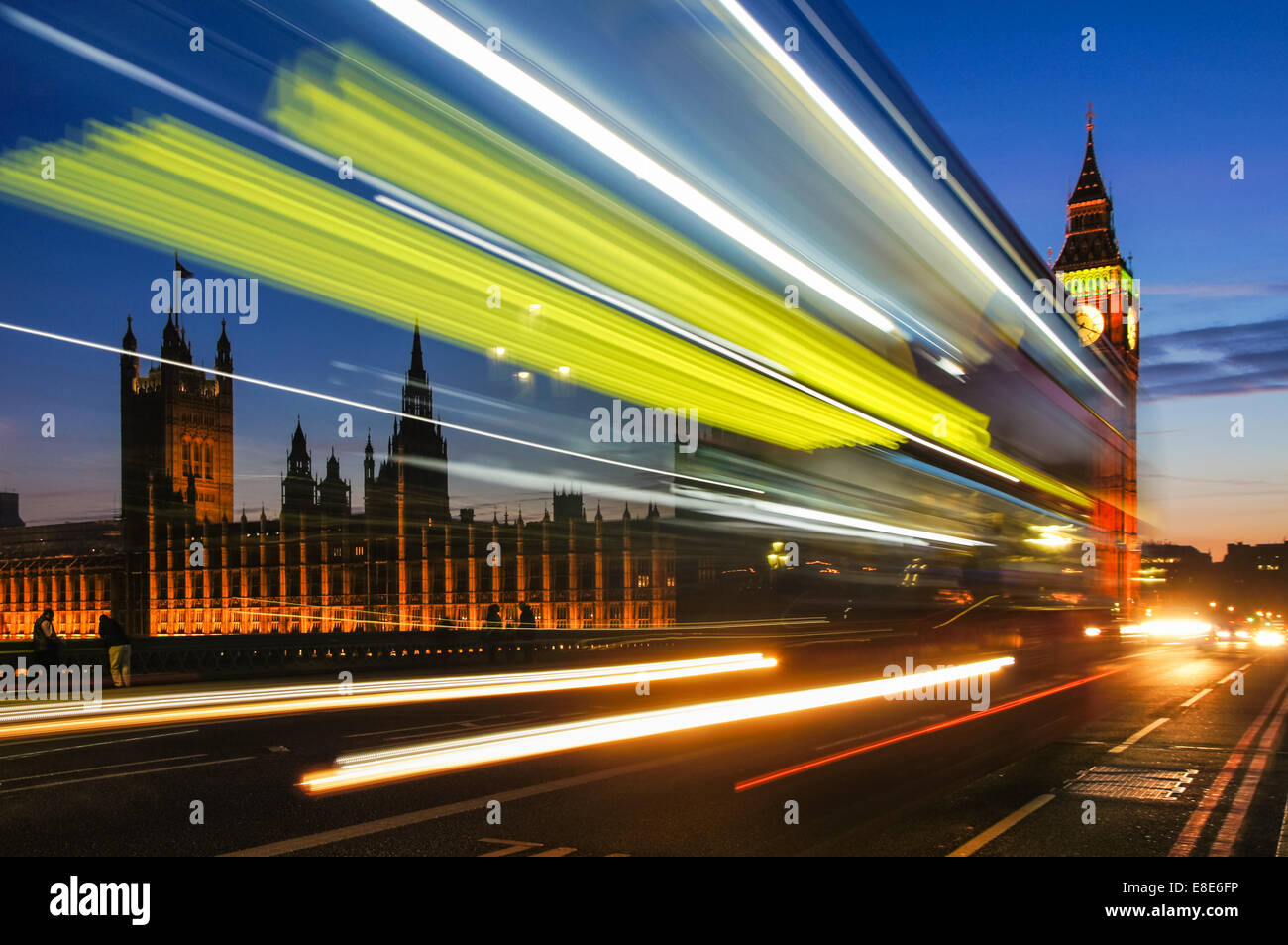 Light trails left by double decker bus passing by Big Ben on Westminster bridge, London England United Kingdom UK Stock Photo