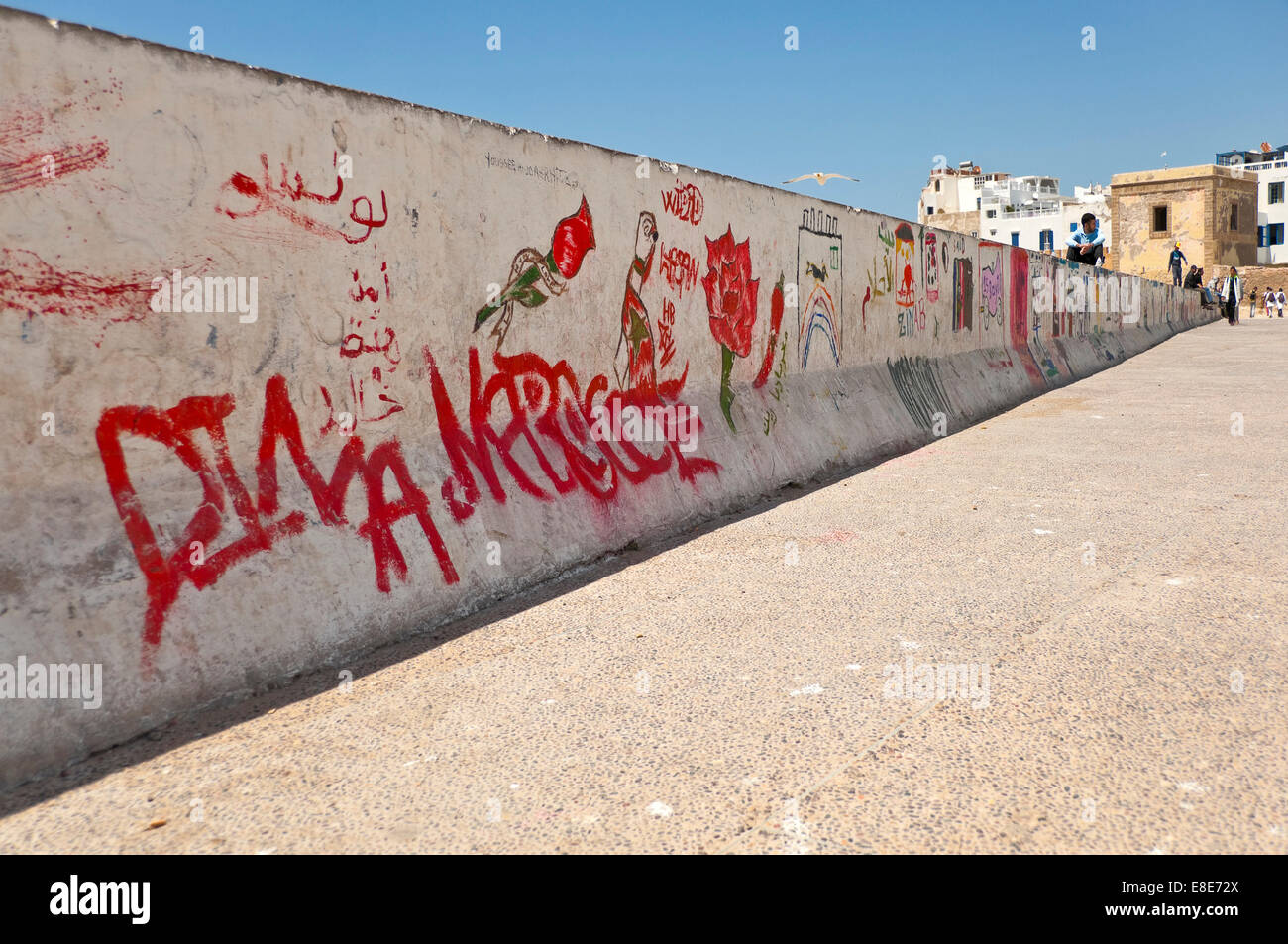 Horizontal view of a wall with graffiti on it in Essaouira. Stock Photo