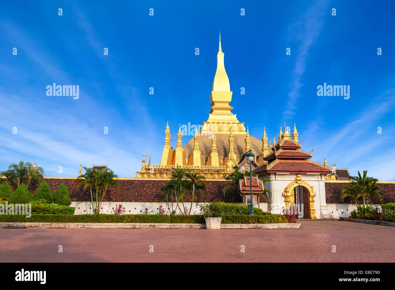 Religious architecture and landmarks. Golden buddhist pagoda of Phra That Luang Temple under blue sky. Vientiane, Laos travel la Stock Photo