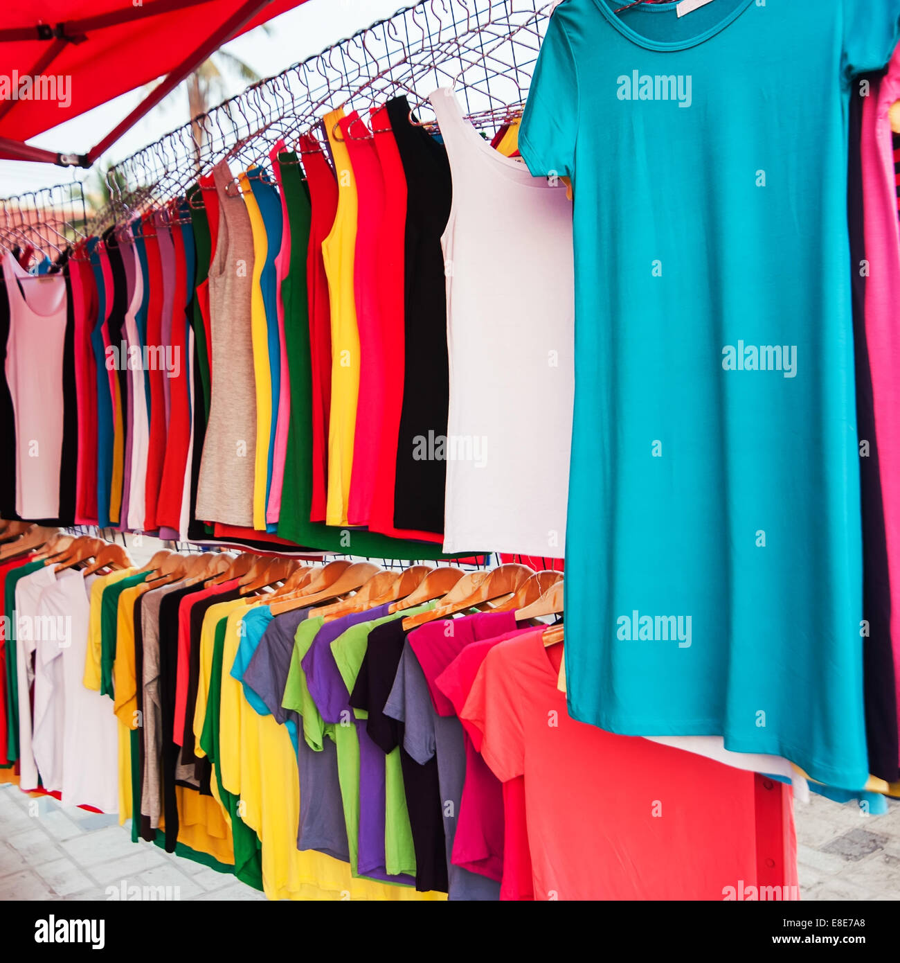A lot of colorful shirts for sale at market Stock Photo
