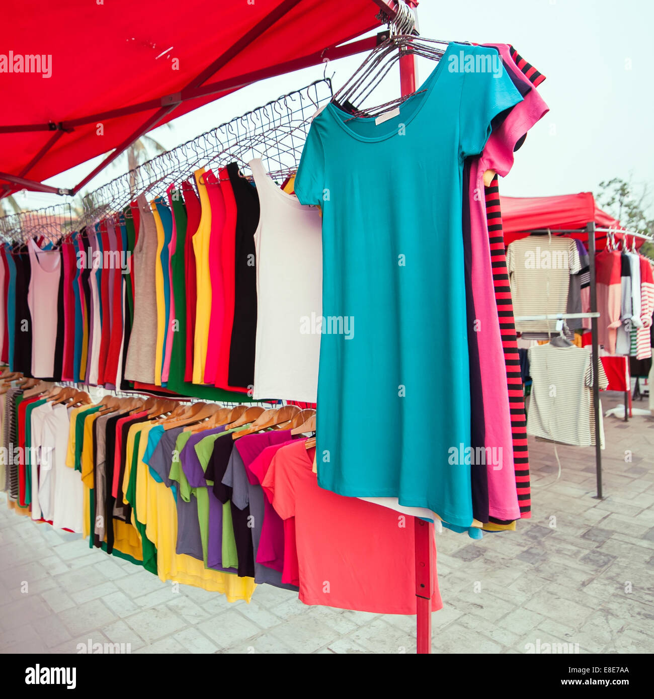 A lot of colorful shirts for sale at market Stock Photo