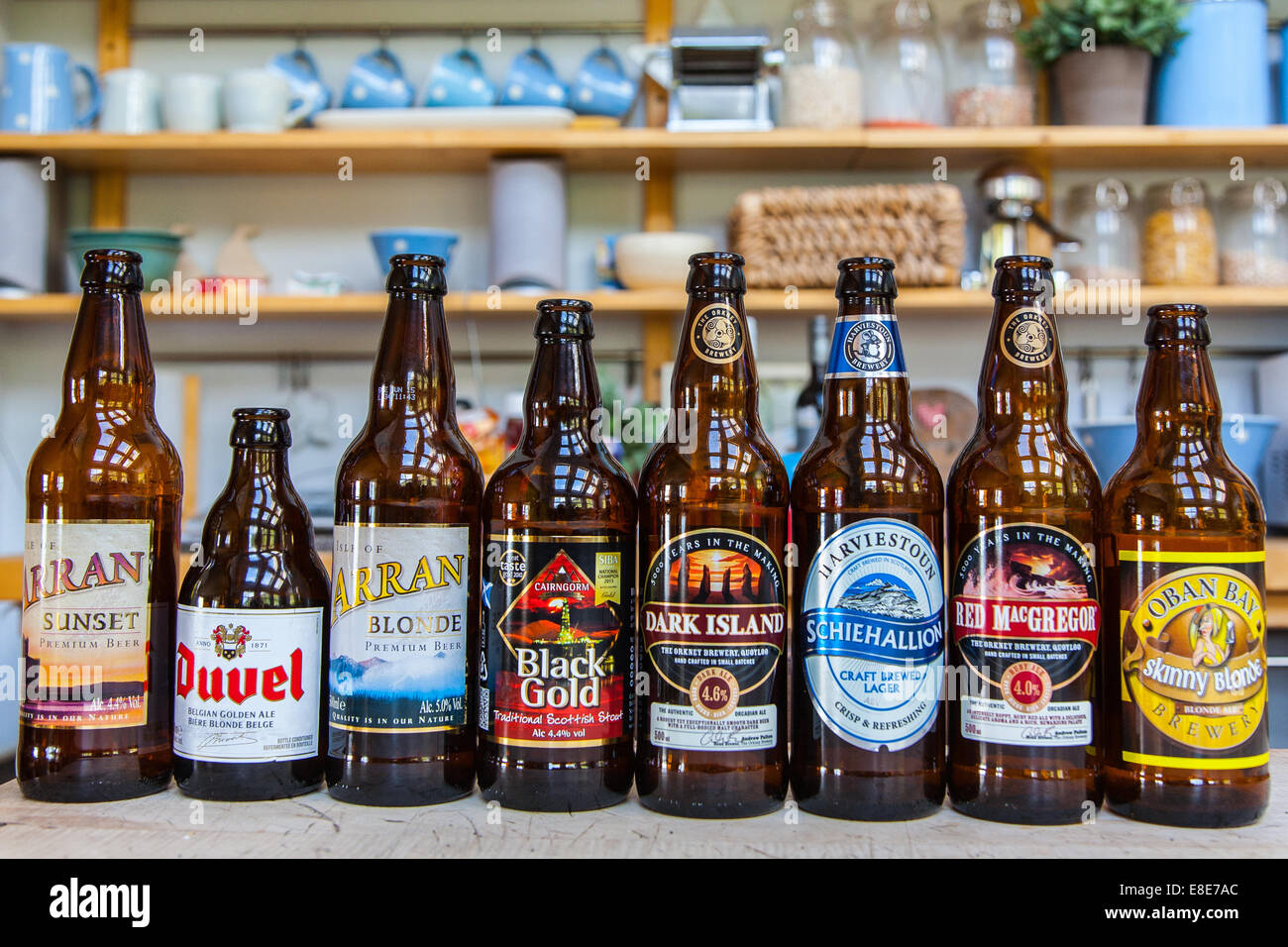 A line of beer & Wine bottles in a cottage kitchen. Stock Photo