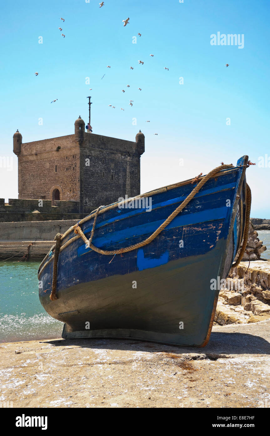Vertical view of the fortress in Essaouira with a moored fishing boat on a sunny day. Stock Photo