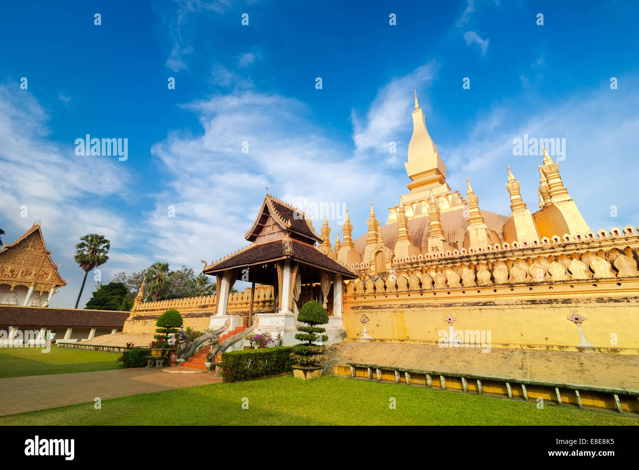 Religious architecture and landmarks. Golden buddhist pagoda of Phra That Luang Temple under blue sky. Vientiane, Laos travel la Stock Photo