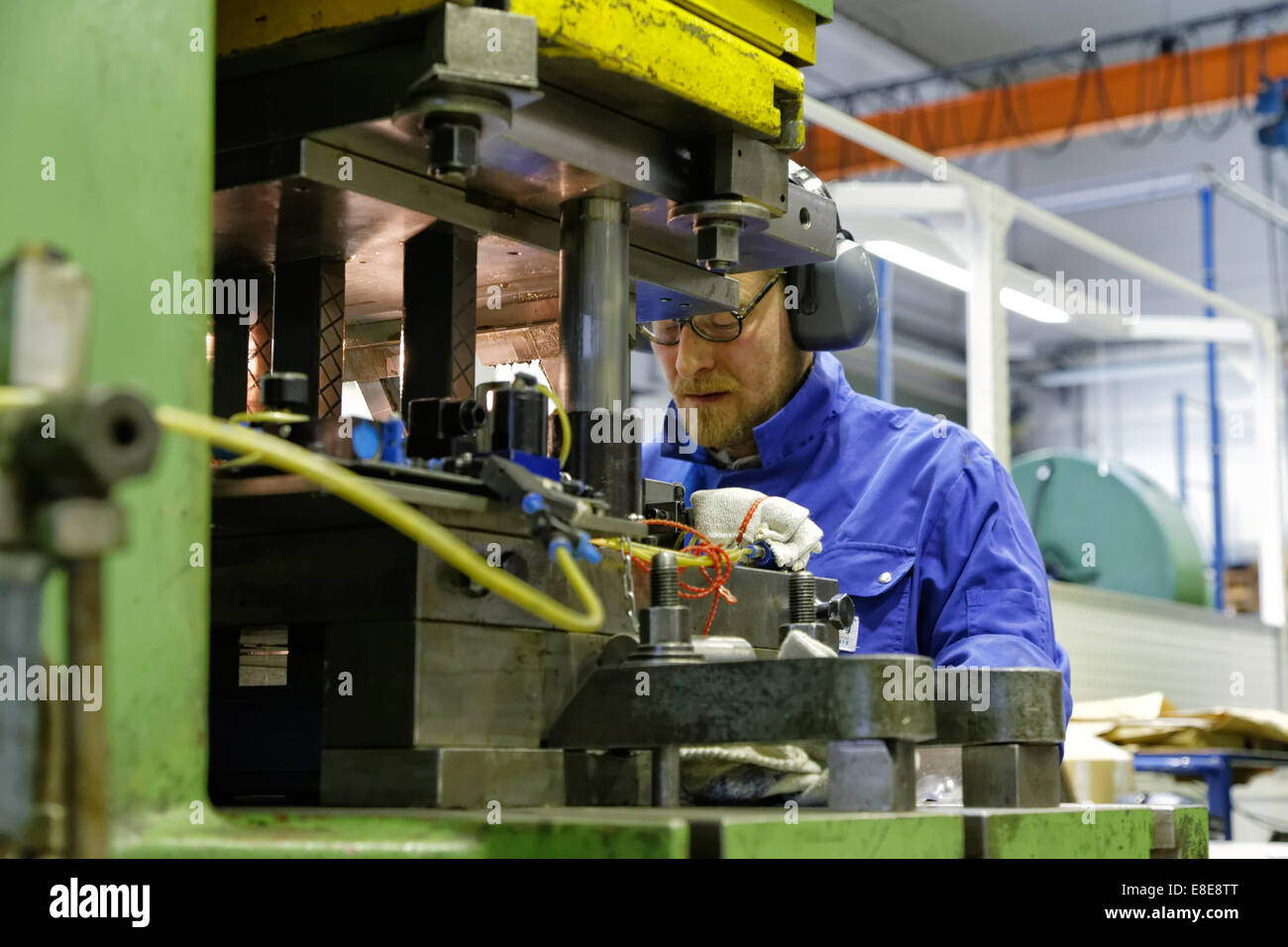 Berlin, Germany, skilled metal worker at a punching machine in the
