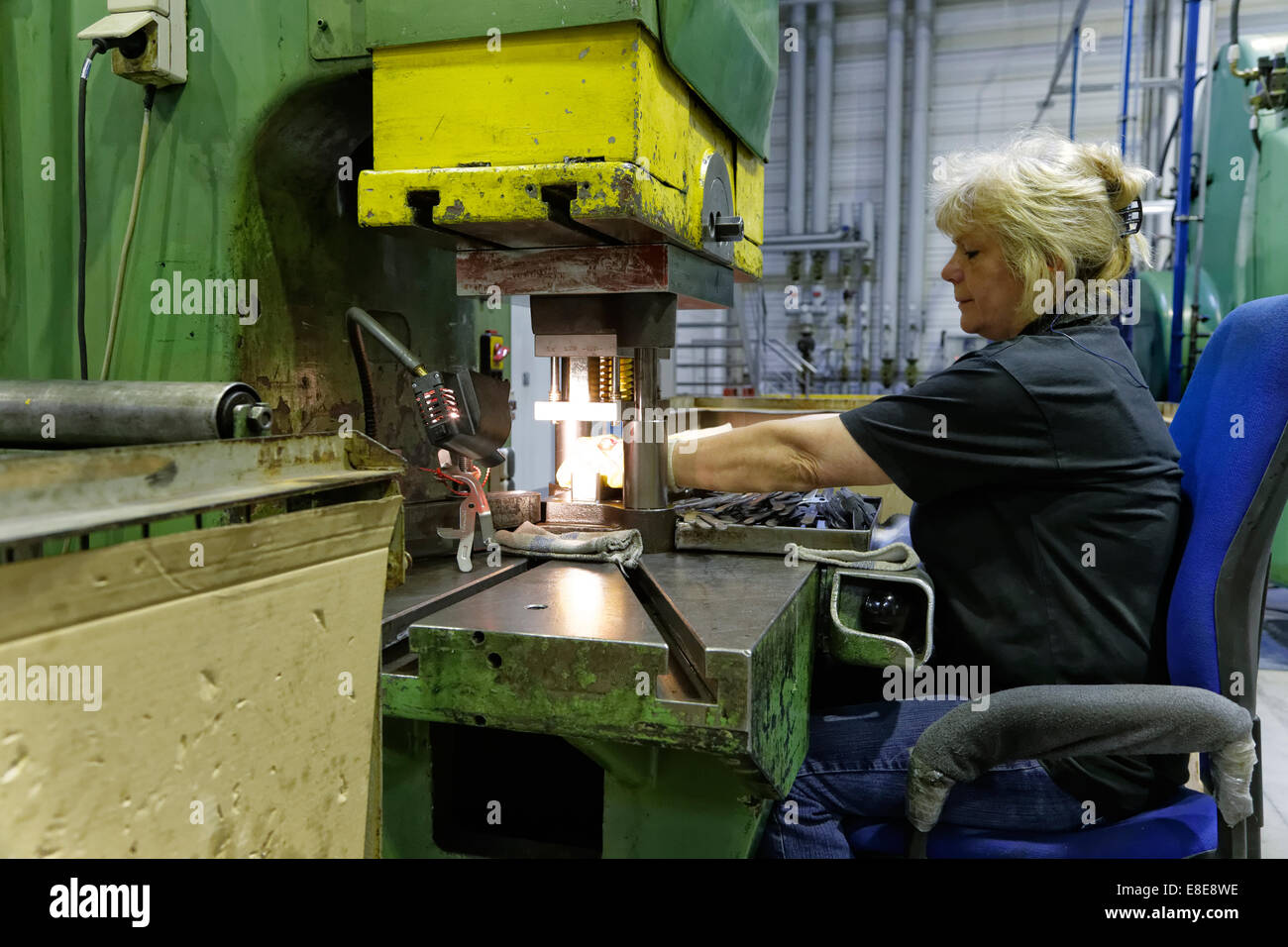 Berlin, Germany, skilled metal worker on a punching machine in the