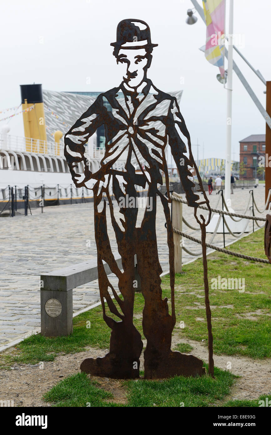 Metal statue of Charlie Chaplin alongside the SS Nomadic in the Titanic Quarter of Belfast Northern Ireland Stock Photo