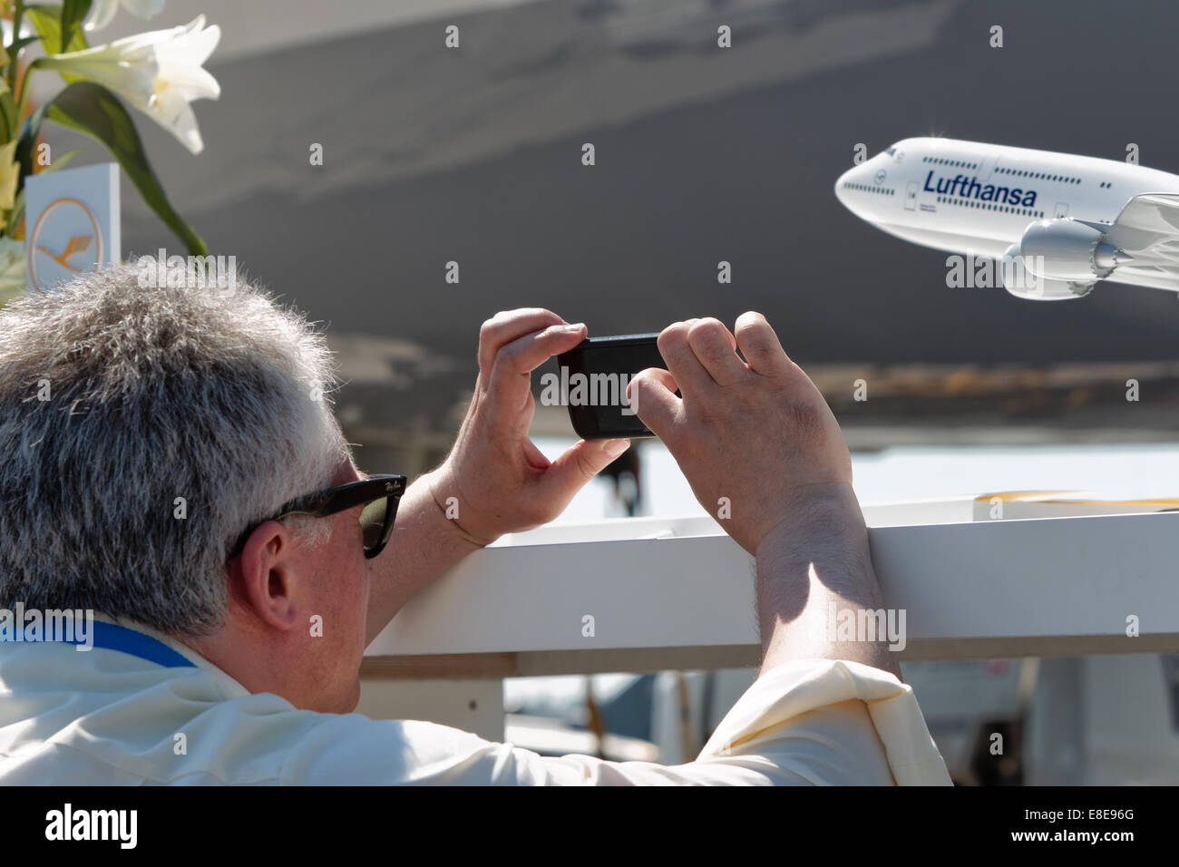 Schoenefeld, Germany, a visitor takes photos at the ILA 2014 Stock Photo