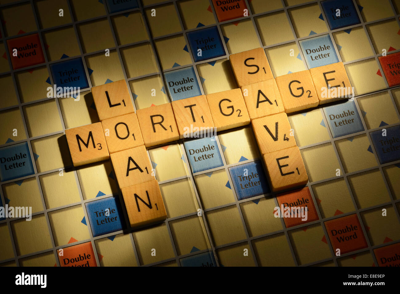 Scrabble board with the words Mortgage Loan Save Stock Photo