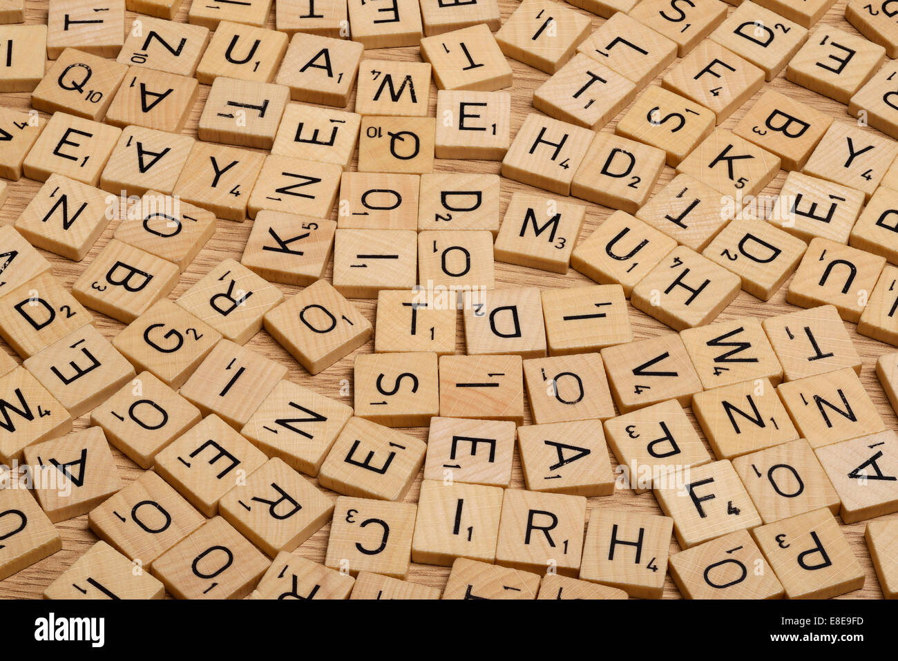 Jumble of wooden Scrabble letter tiles Stock Photo