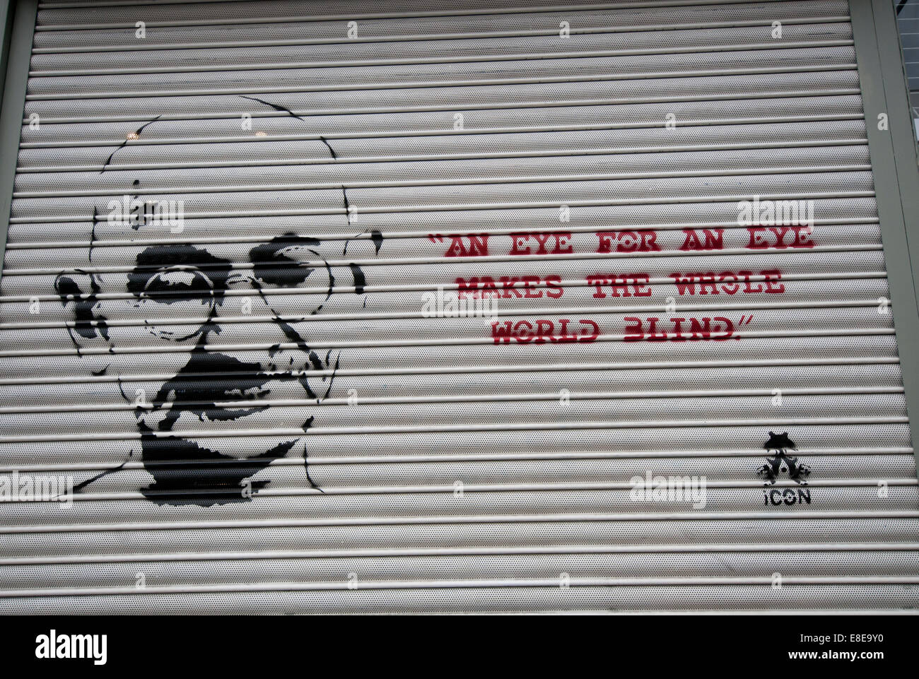 Quote from Gandhi 'An eye for an eye makes the whole world blind' graffitied on wall Stock Photo