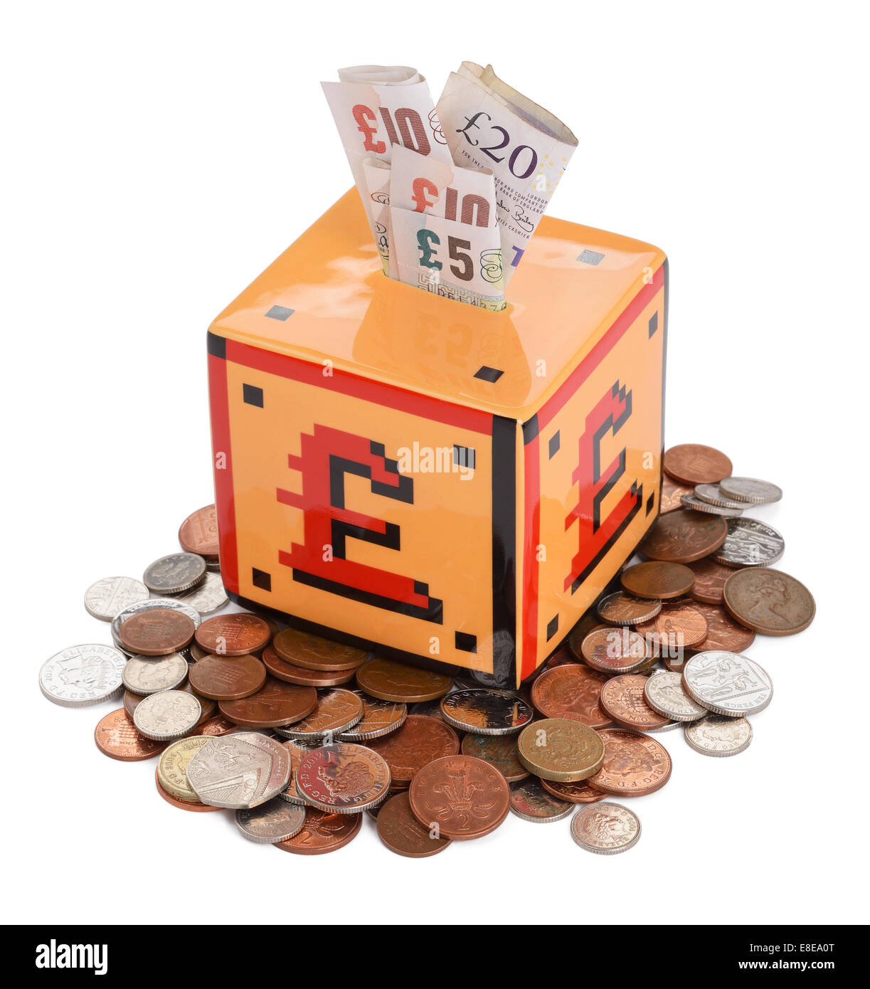 Money box with UK sterling coins and notes Stock Photo