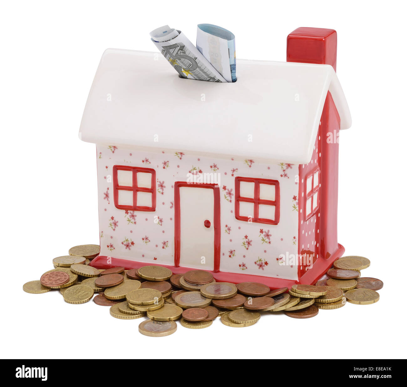 House shaped piggy bank with Euro coins and notes Stock Photo