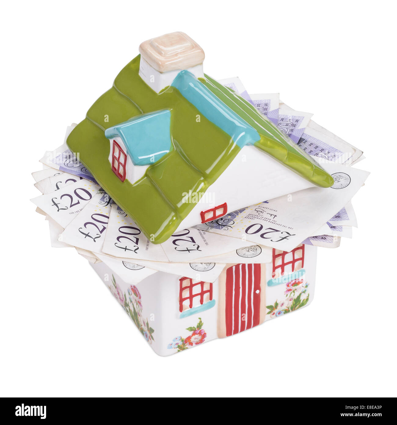 House shaped money box stuffed with cash Stock Photo