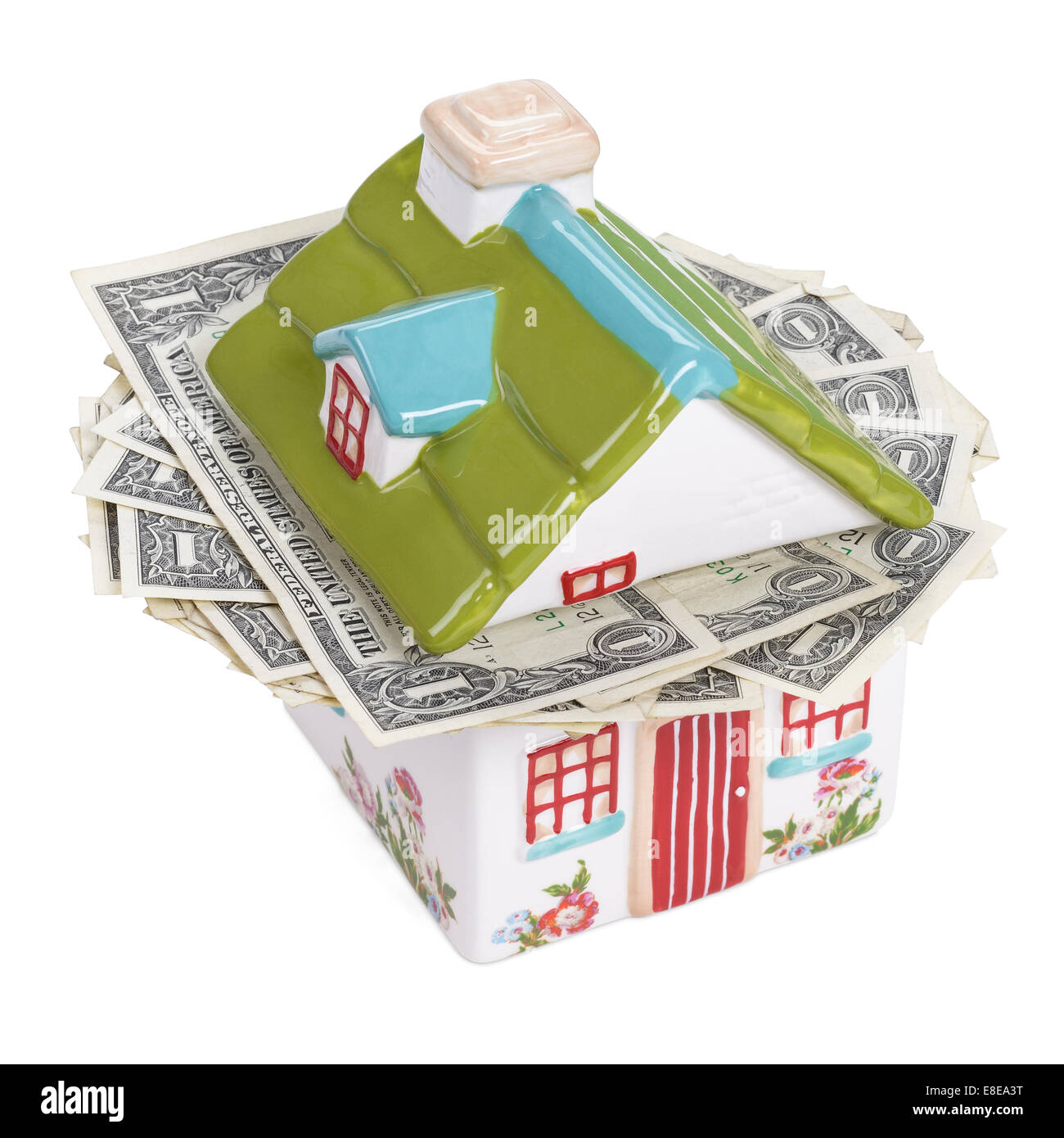 House shaped money box stuffed with cash Stock Photo