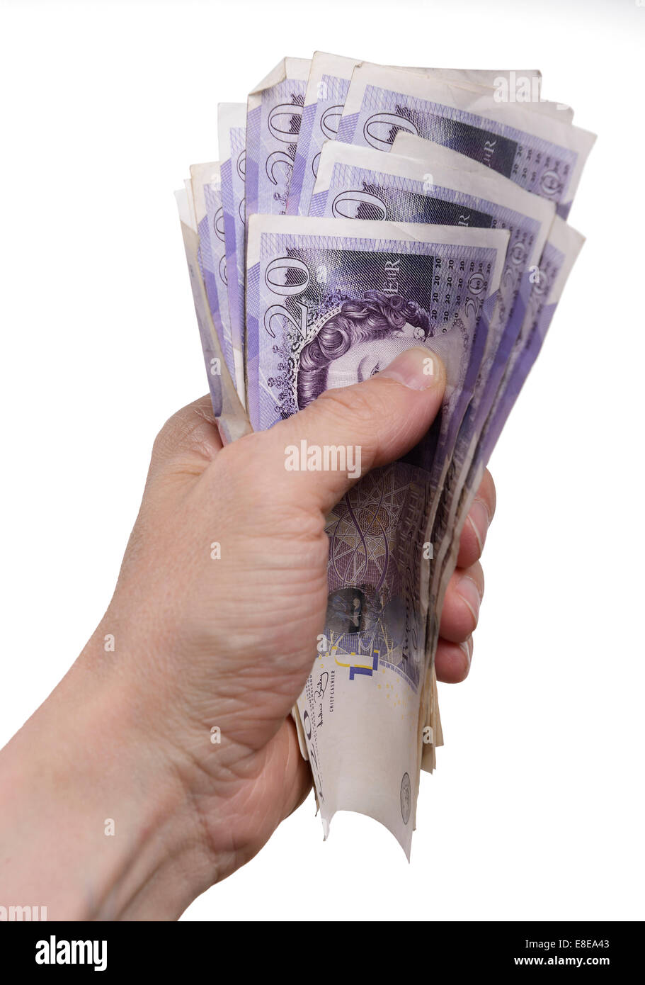 Mans hand holding a bundle of UK Twenty Pound notes Stock Photo