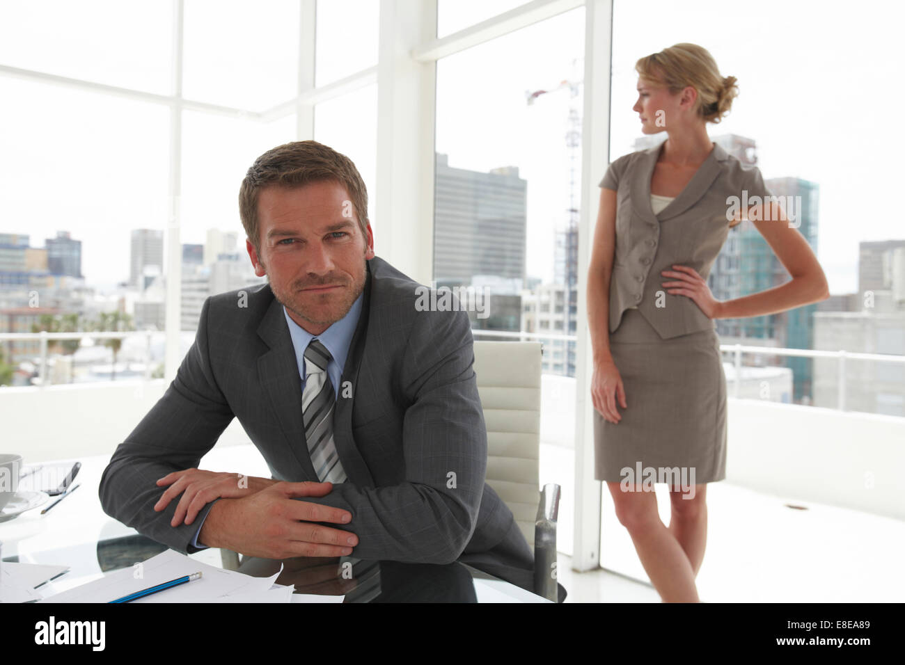 Young man with woman in the background Stock Photo