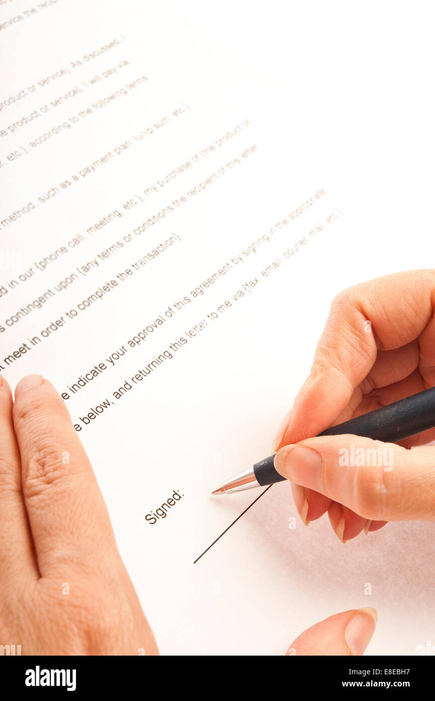 woman hands signing a contract Stock Photo