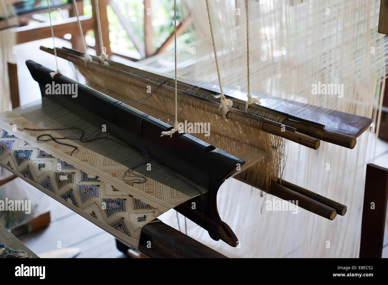 Vintage manual weaving loom with unfinished textile work Stock Photo