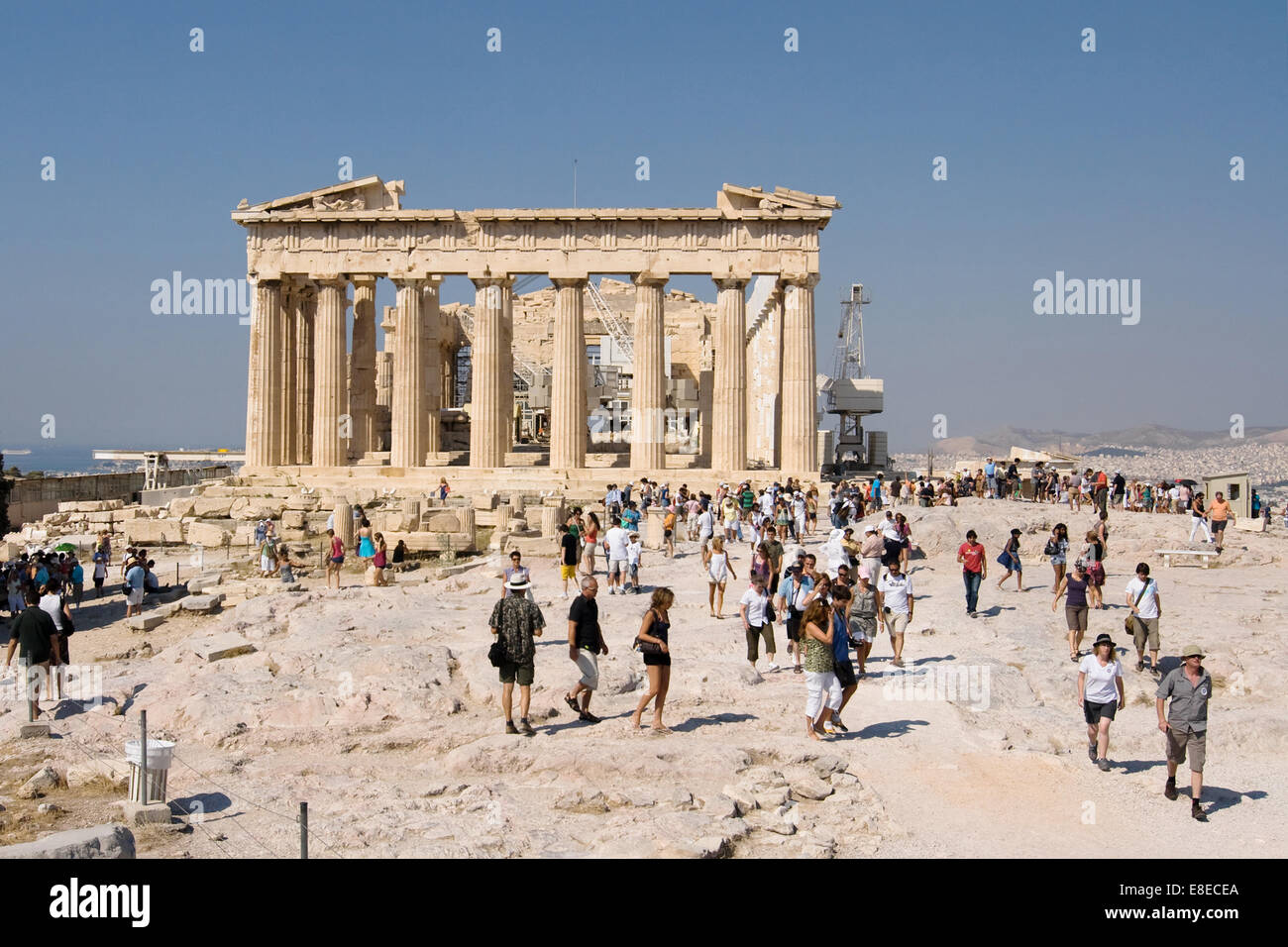 Crowds visiting the archaeological site of the Acropolis in Athens, Greece. View of the Parthenon in the background. Stock Photo