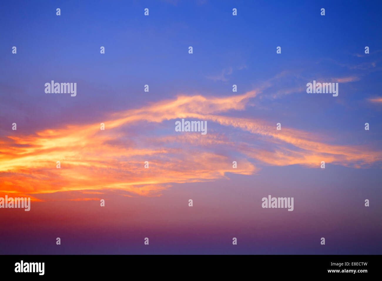 Beautiful blue sunset sky with orange clouds Stock Photo