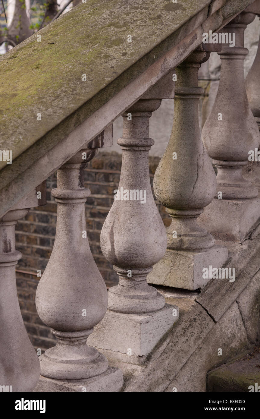 Stone balusters and a moss cover railing. Stock Photo