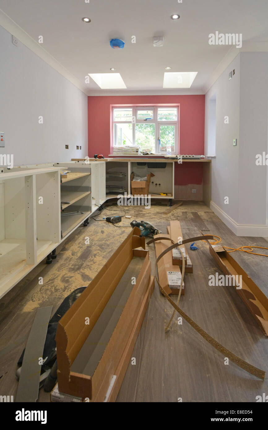 Kitchen cabinets being installed in new extension to detached house Essex England UK see 'More Info' note below Stock Photo