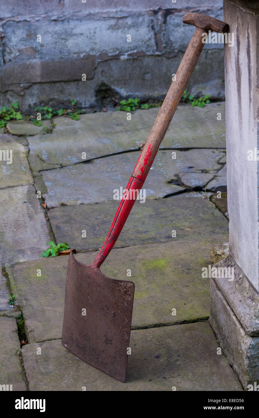 A shovel leaning against a wall. Stock Photo